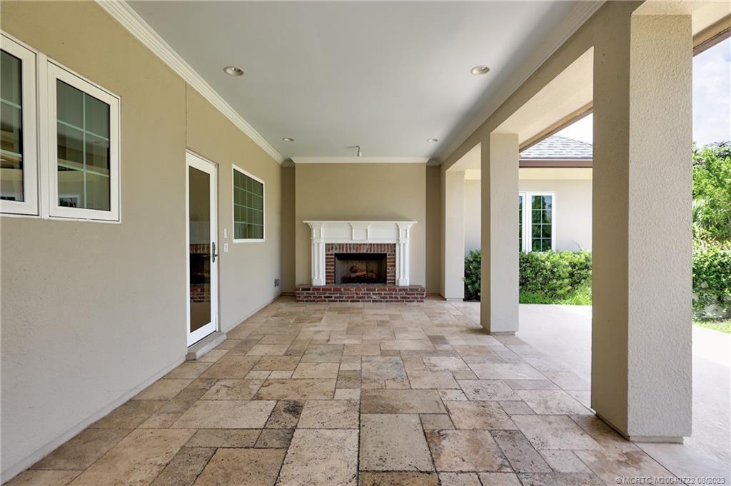 4865 Southeast Manatee Cove Road Stuart, FL 34997 - Photo 50 of 53 a view of a big room with windows and a fireplace