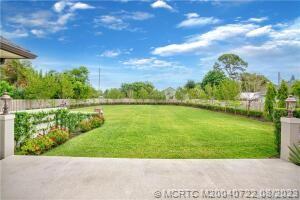 4865 Southeast Manatee Cove Road Stuart, FL 34997 - Photo 5 of 53 a view of a lake with a big yard