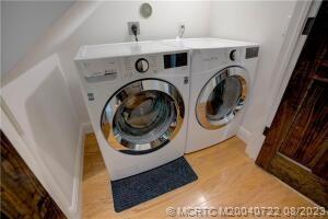 4865 Southeast Manatee Cove Road Stuart, FL 34997 - Photo 51 of 53 a utility room with dryer and washer