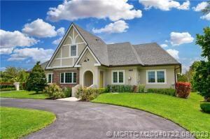 4865 Southeast Manatee Cove Road Stuart, FL 34997 - Photo 53 of 53 a front view of house with yard and green space