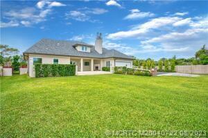 4865 Southeast Manatee Cove Road Stuart, FL 34997 - Photo 6 of 53 a front view of house with yard and green space