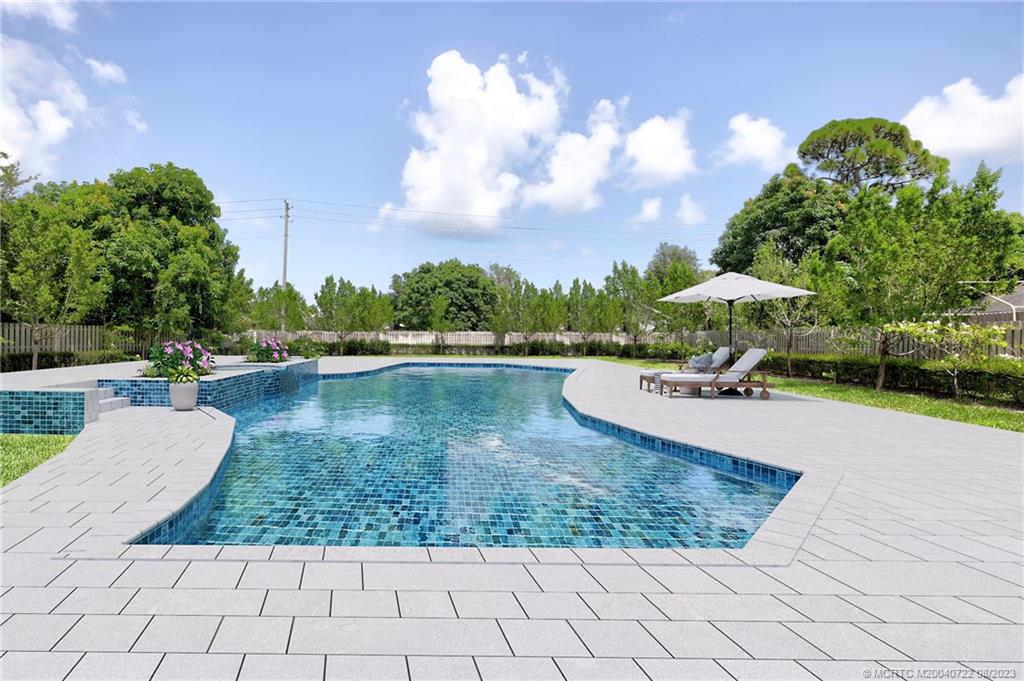 4865 Southeast Manatee Cove Road Stuart, FL 34997 - Photo 7 of 53 a view of a lake with houses