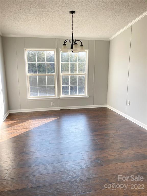 872 Harris Bridge Road, Unit 1 & 2 Stony Point, NC 28678 - Photo 8 of 31 an empty room with wooden floor and windows