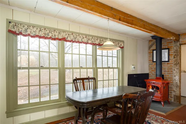a dining room with furniture a chandelier and wooden floor