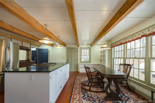 a view of a dining room with furniture a chandelier and wooden floor