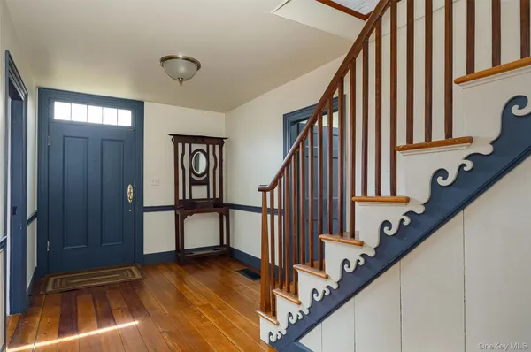 a view of an entryway with wooden floor and stairs