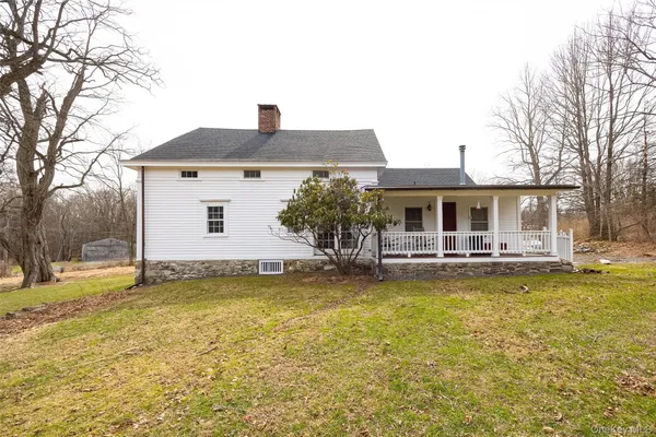 a view of a house with swimming pool and a yard