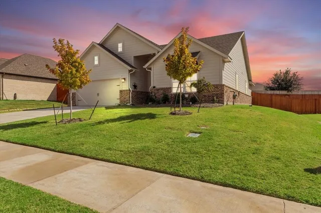 a view of a house with a big yard and potted plants