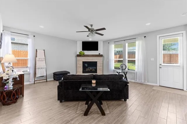 a living room with furniture fireplace and flat screen tv