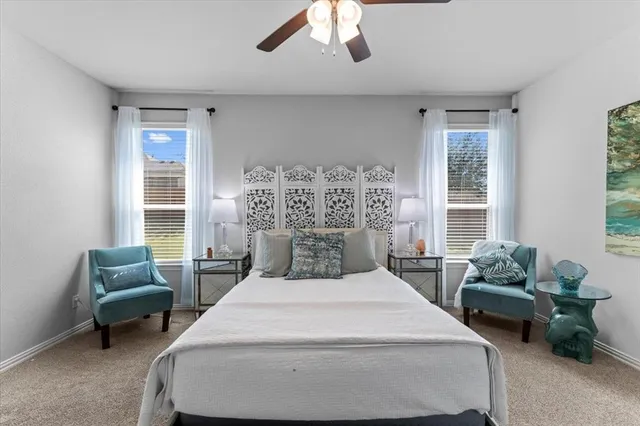 a bedroom with a bed and a large window