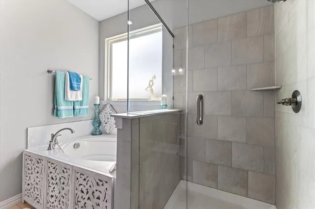 a bathroom with a bathtub and shower