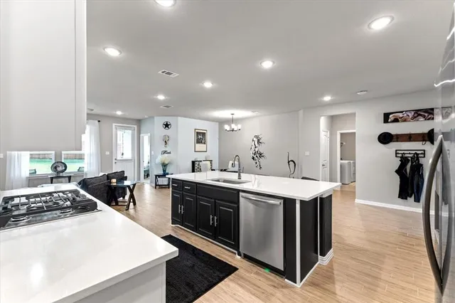 a large kitchen with stainless steel appliances lots of counter top space