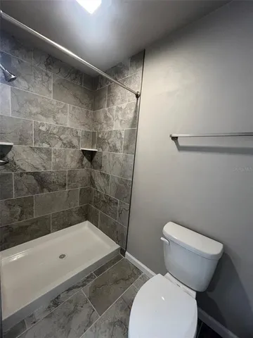 a bathroom with a toilet and shower