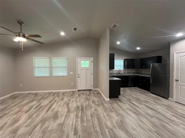 a kitchen with stainless steel appliances kitchen island wooden cabinets and granite counter tops