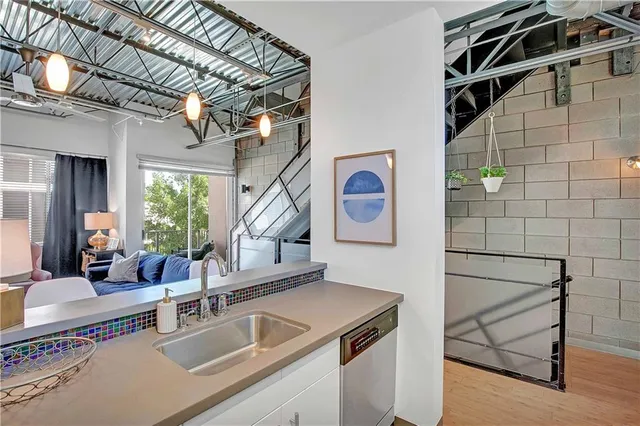 a kitchen with a sink and a stove next to a window