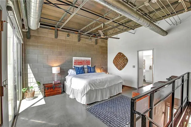 a bed sitting in a bedroom next to a window