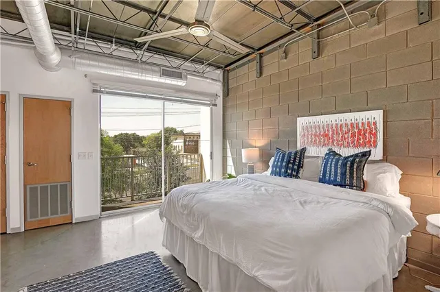 a bedroom with a bed and a window