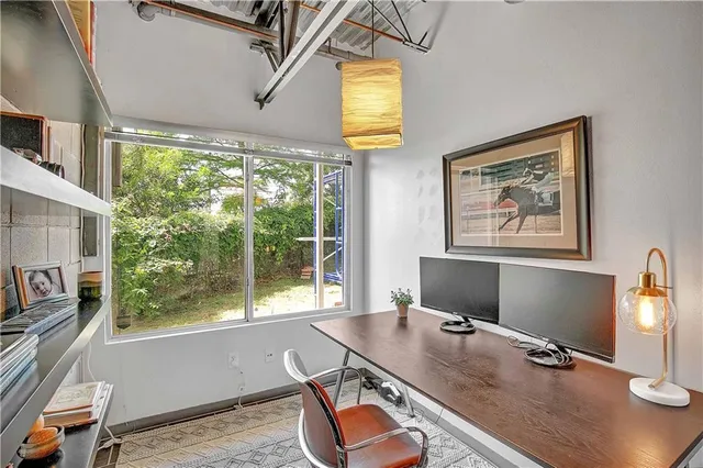 a workspace with furniture and window