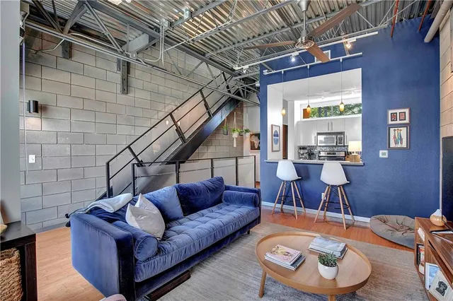 a living room with furniture and a wooden floor