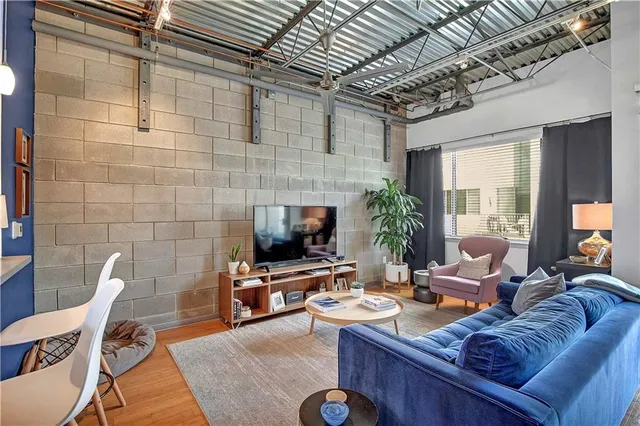 a living room with furniture a fireplace and a potted plant