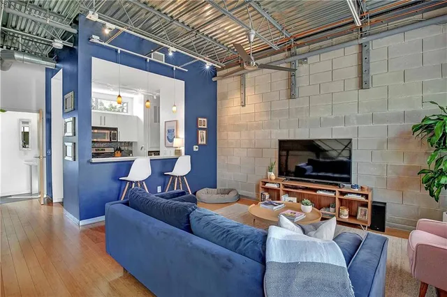 a living room with furniture flat screen tv and a fireplace