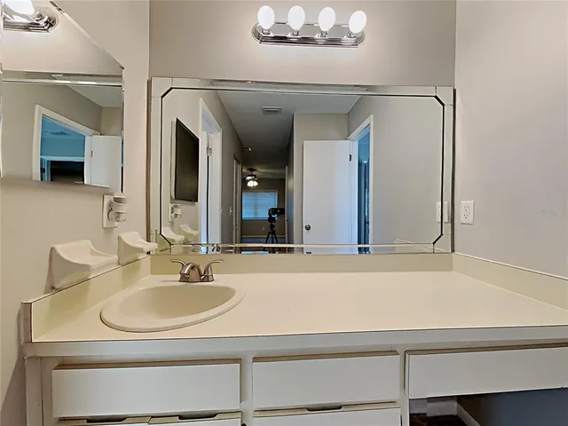 a bathroom with a sink and a mirror