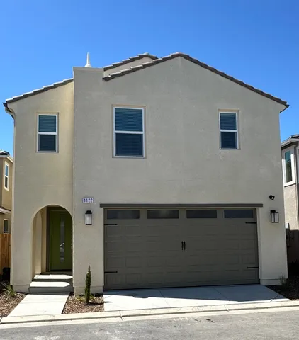 a front view of a house with garage