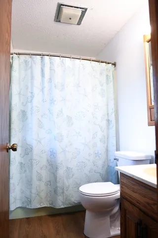 a bathroom with a toilet a sink and a shower