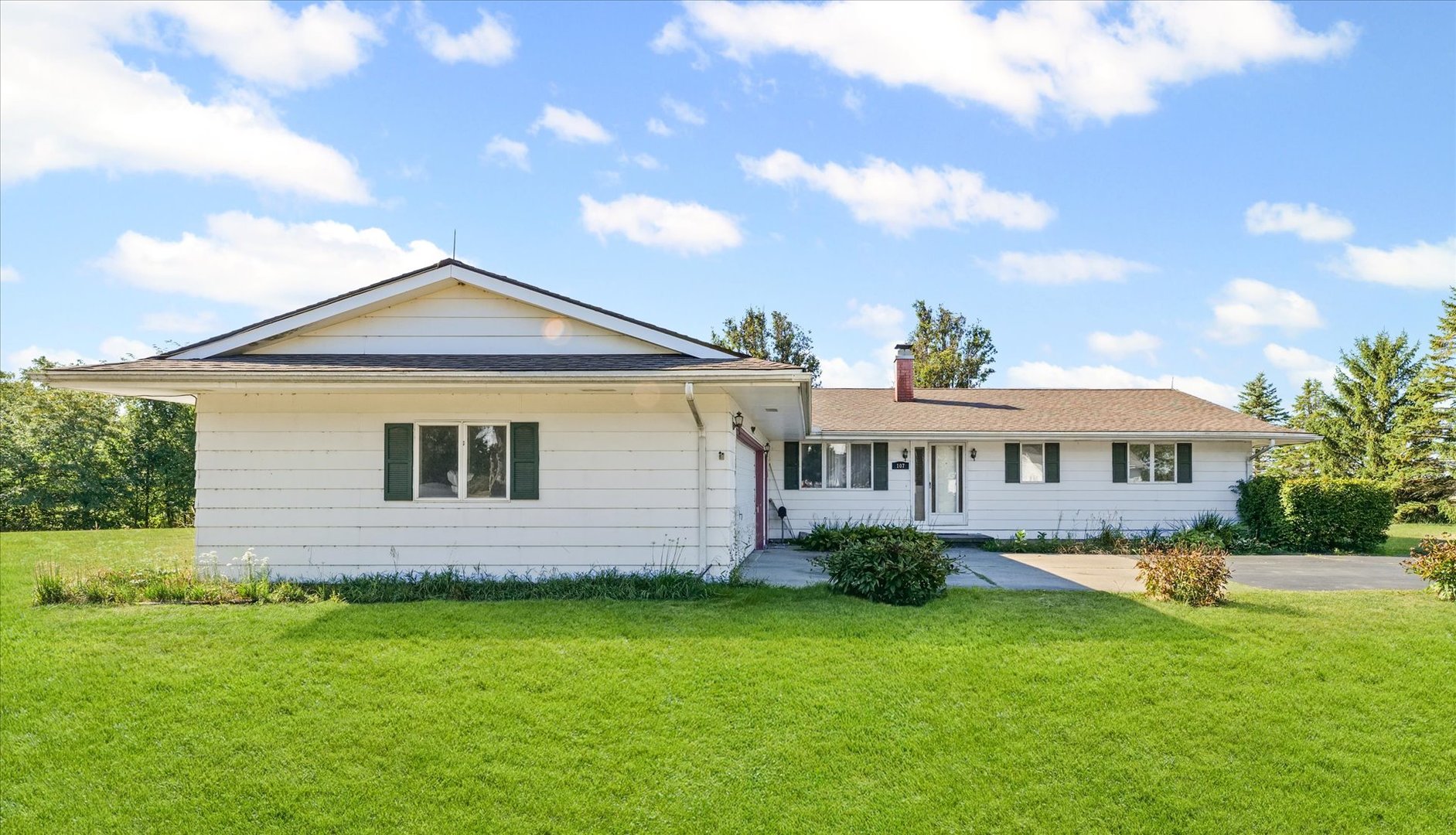 107 Walnut Street Penfield, IL 61862 - Photo 2 of 34 a front view of a house with a garden
