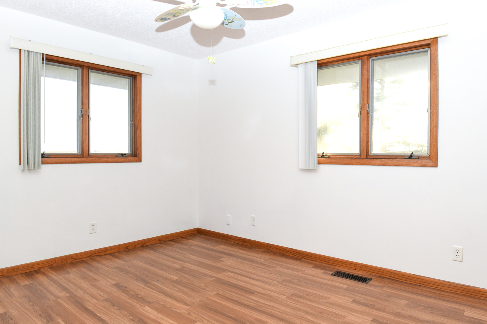 107 Walnut Street Penfield, IL 61862 - Photo 25 of 34 an empty room with wooden floor and windows