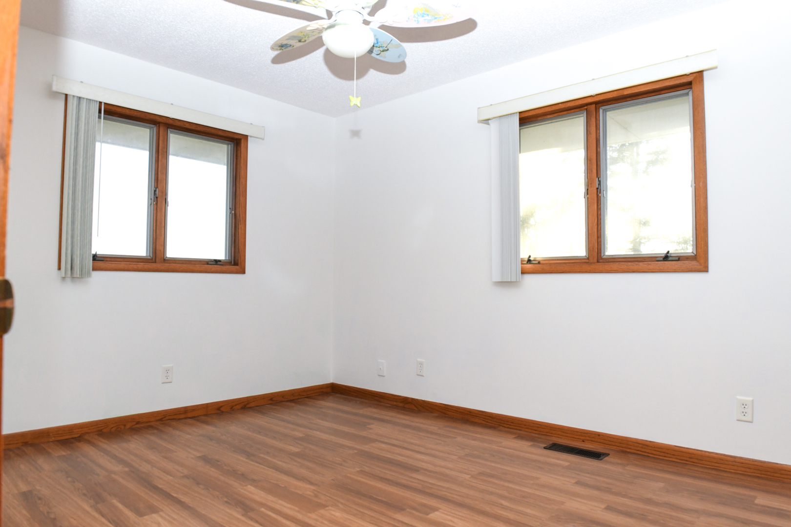 107 Walnut Street Penfield, IL 61862 - Photo 27 of 34 a view of an empty room with wooden floor and a window