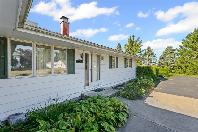 a front view of a house with a garden