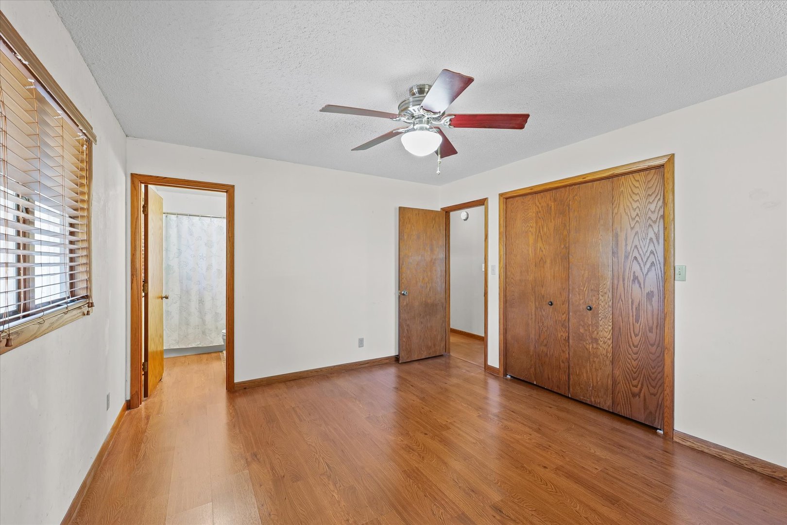 107 Walnut Street Penfield, IL 61862 - Photo 9 of 34 a view of empty room with wooden floor and fan