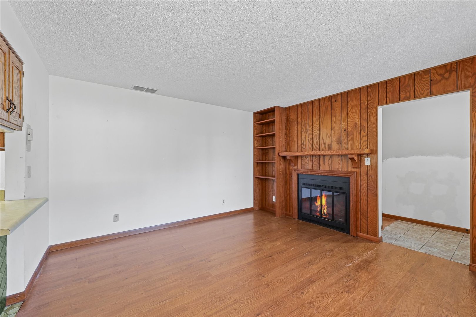 107 Walnut Street Penfield, IL 61862 - Photo 10 of 34 a view of an empty room with a fireplace