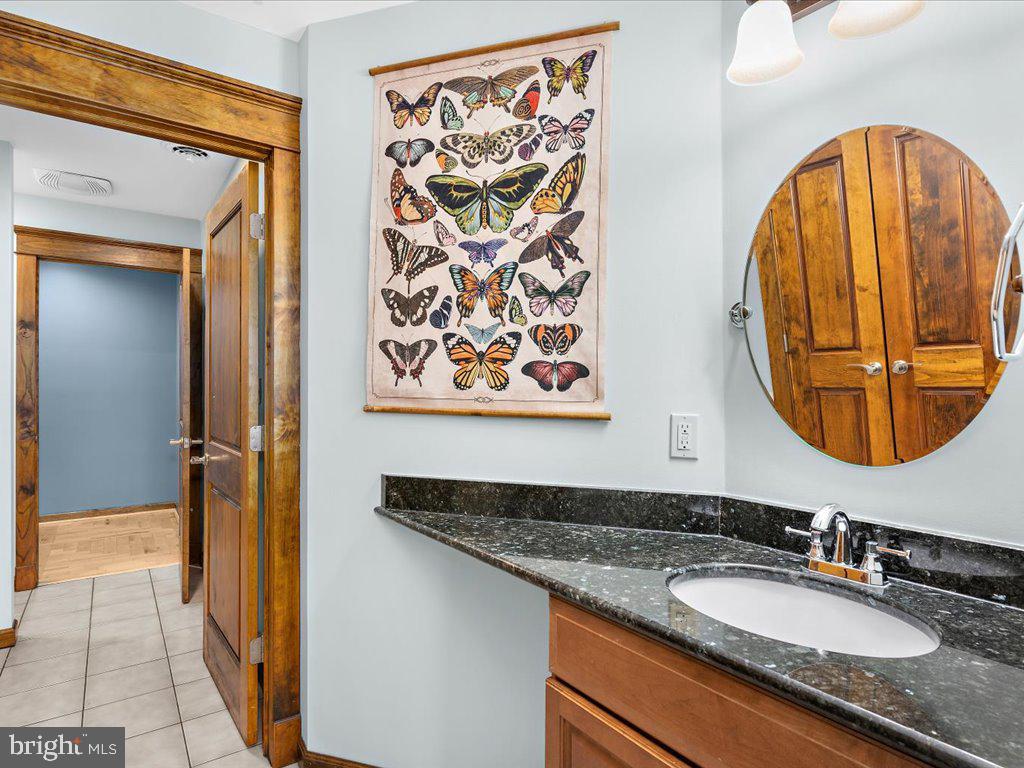 4404 Pine Top Road Madison, MD 21648 - Photo 53 of 68 a bathroom with a granite countertop sink and a mirror