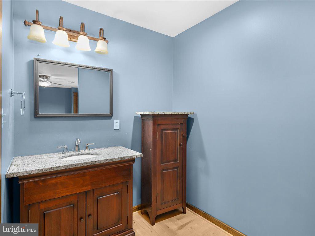 4404 Pine Top Road Madison, MD 21648 - Photo 55 of 68 a bathroom with a sink and a mirror