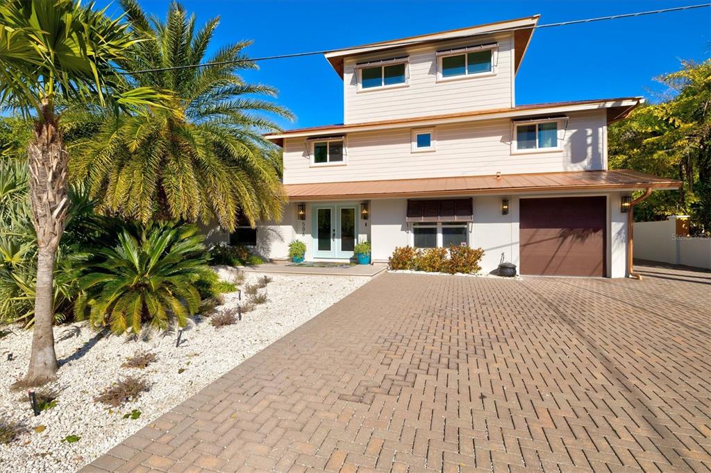 506 58th Street Holmes Beach, FL 34217 - Photo 2 of 95 a front view of a house with a yard