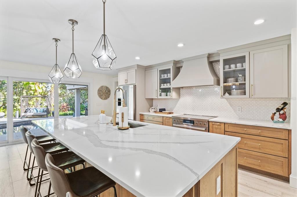 506 58th Street Holmes Beach, FL 34217 - Photo 21 of 95 a kitchen with a table chairs and wooden floor