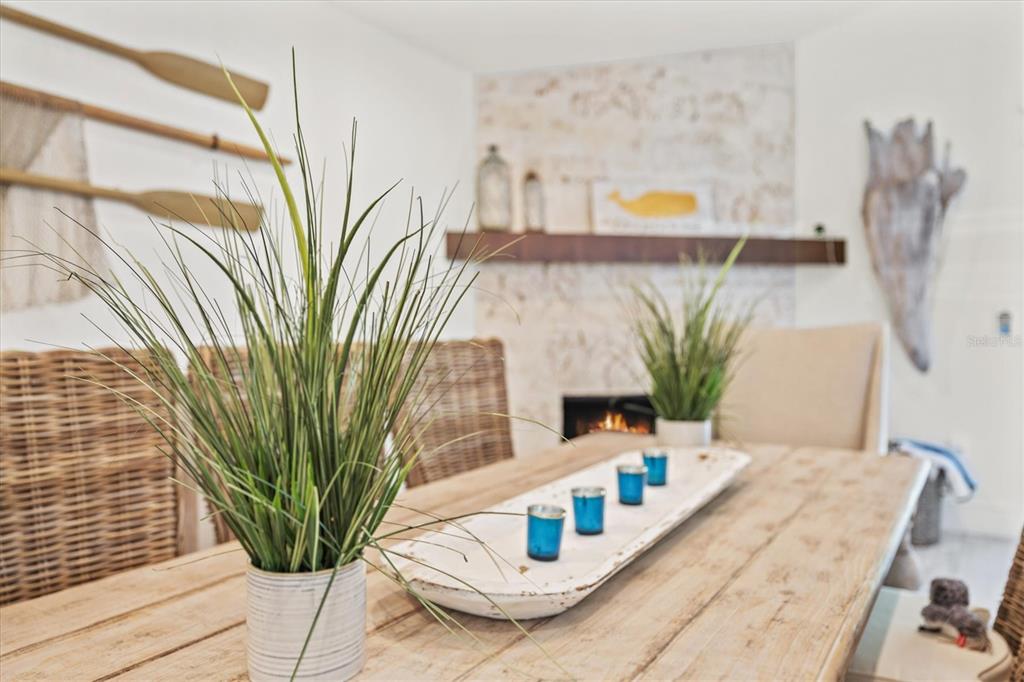 506 58th Street Holmes Beach, FL 34217 - Photo 30 of 96 a vase of flowers sitting on a table with wooden floor