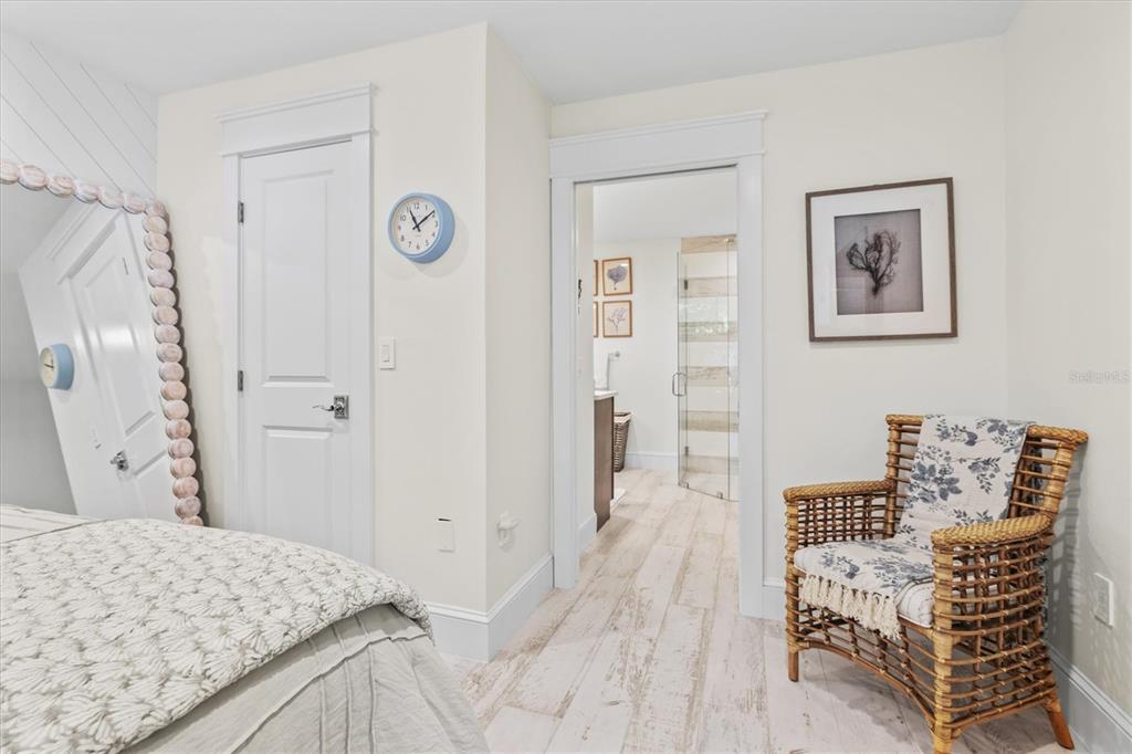 506 58th Street Holmes Beach, FL 34217 - Photo 40 of 95 a bedroom with a bed and a table in it