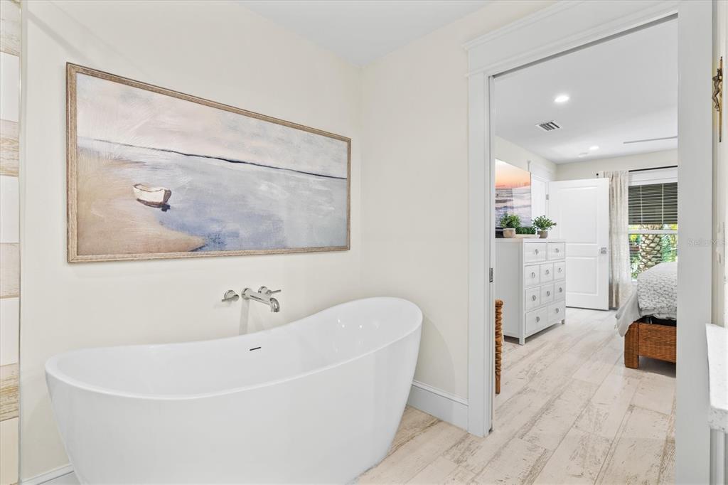 506 58th Street Holmes Beach, FL 34217 - Photo 41 of 95 a white bath tub sitting next to a bathroom