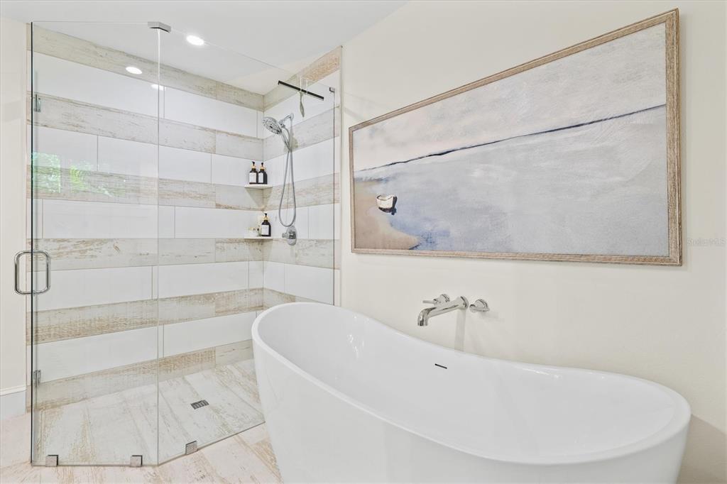 506 58th Street Holmes Beach, FL 34217 - Photo 42 of 95 a bathroom with a bathtub and shower