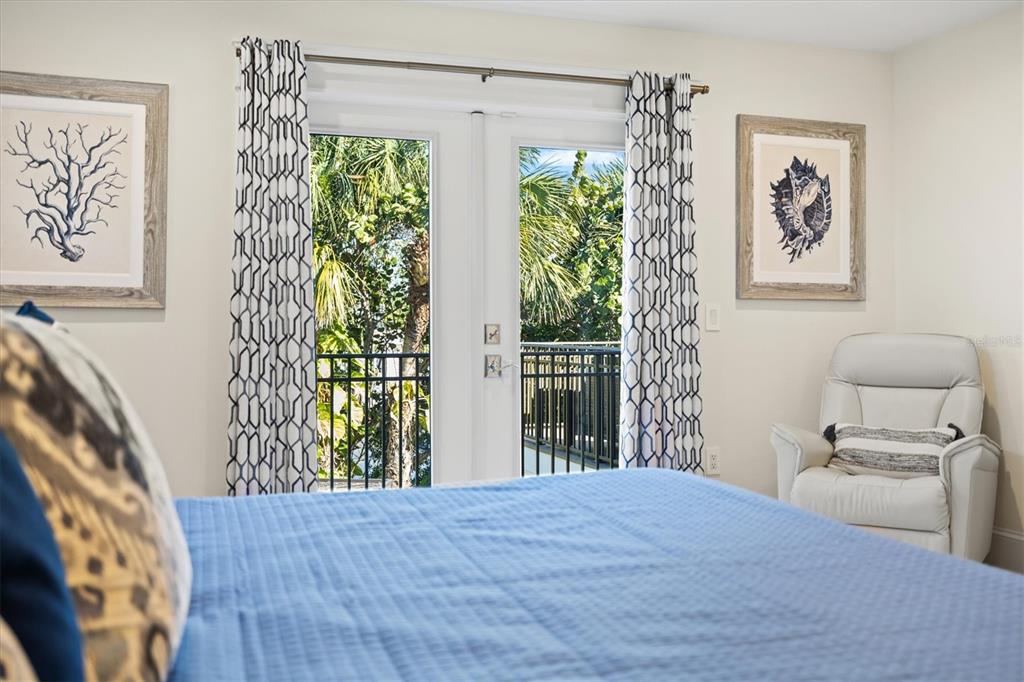 506 58th Street Holmes Beach, FL 34217 - Photo 43 of 96 a bedroom with a bed and a painting on the wall