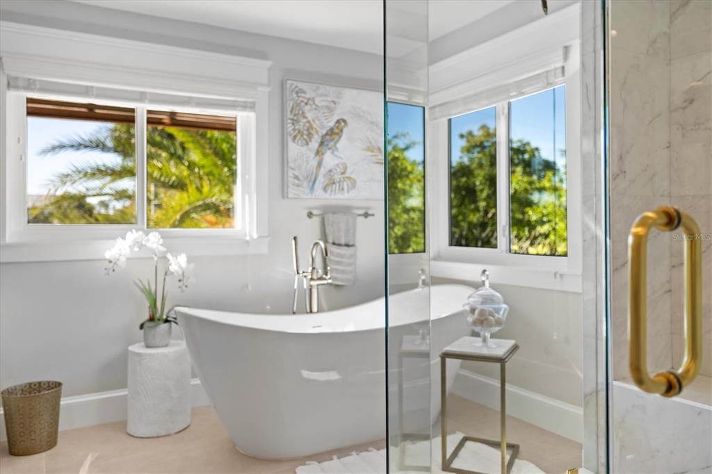 506 58th Street Holmes Beach, FL 34217 - Photo 49 of 96 a white bath tub sitting in a bathroom next to a window
