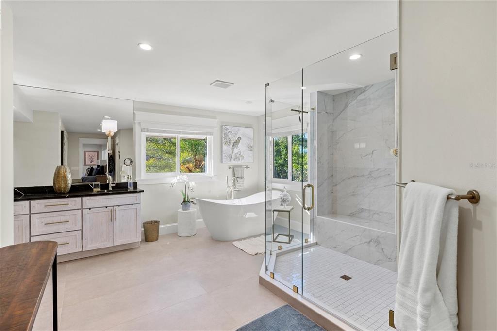 506 58th Street Holmes Beach, FL 34217 - Photo 52 of 95 a large bathroom with a large tub shower and sink