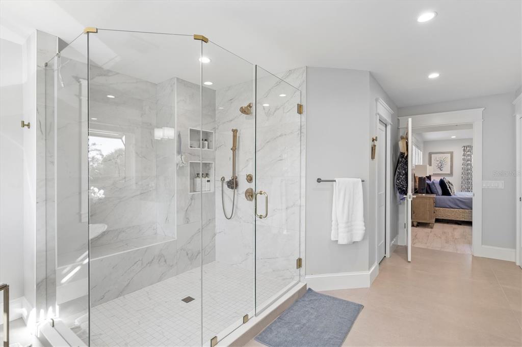 506 58th Street Holmes Beach, FL 34217 - Photo 55 of 95 a bathroom with a shower and a tub