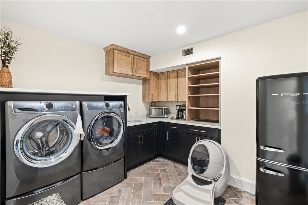 506 58th Street Holmes Beach, FL 34217 - Photo 61 of 95 a utility room with sink dryer and washer