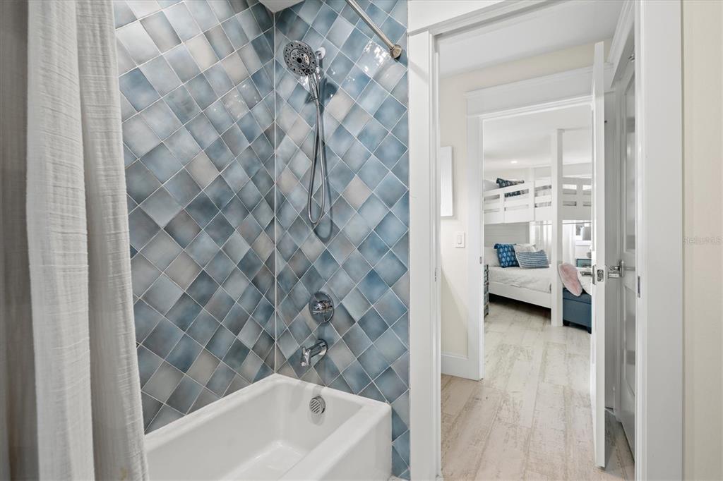 506 58th Street Holmes Beach, FL 34217 - Photo 65 of 96 a en suite bathroom with a bathtub and a shower