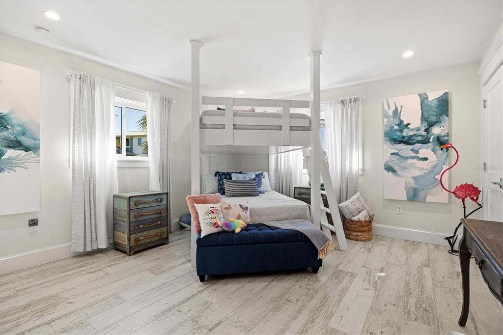 506 58th Street Holmes Beach, FL 34217 - Photo 66 of 96 a bedroom with furniture and a wooden floor