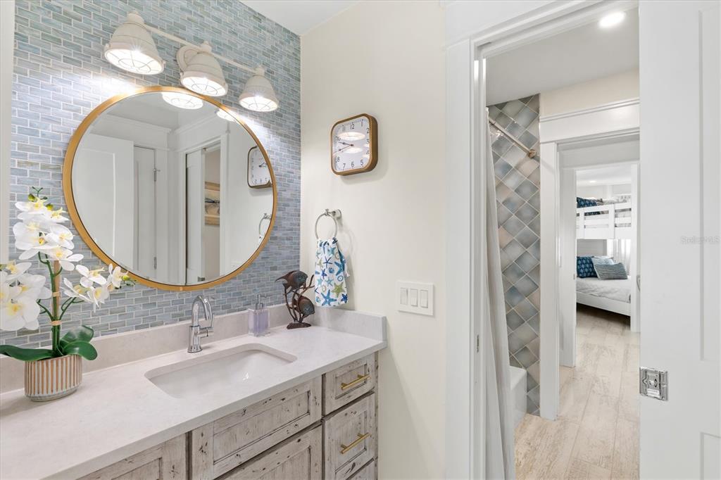 506 58th Street Holmes Beach, FL 34217 - Photo 67 of 95 a bathroom with a sink and a mirror
